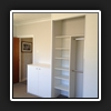 Desktop and storage unit on left side of robe.