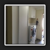 Finished Product. New linen press robe on the left side and new hinged cabinet above tub.