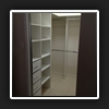 WIR16(2) - View looking from bedroom into WIR showing drawer, shelving units and hanging space.
